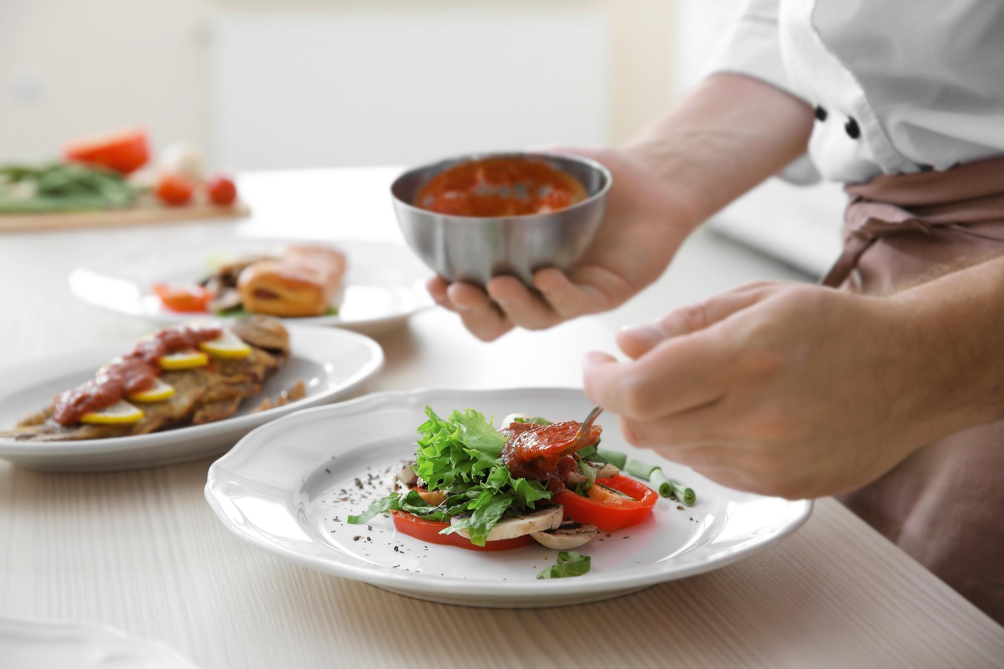 chef assembling a quick plated meal on a wooden counter